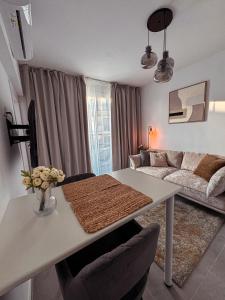 a living room with a table and a couch at Cozy & Stylish 1Bedroom Apartment in Limassol