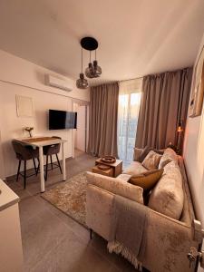 a living room with a couch and a table at Cozy & Stylish 1Bedroom Apartment in Limassol