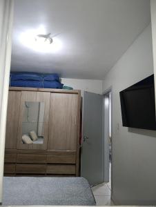 a bedroom with a bed and a mirror and a tv at Casa Cintia COP 30 in Marituba