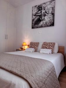 a bedroom with two beds and a painting on the wall at Cozy & Stylish 1Bedroom Apartment in Limassol