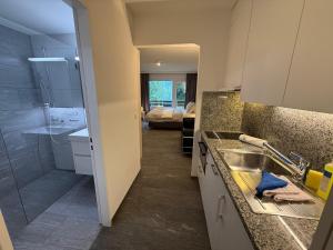 a kitchen with a sink and a shower in a room at Irmella 9 by Arosa Holiday - new renovated in Arosa