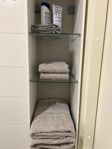 a walk in closet with towels on shelves at Kiva yksiö kahdelle in Turku