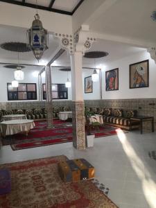 a room with tables and rugs on the walls at Auberge Kasbah Amoun in Taliouine