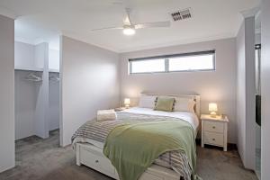 a small bedroom with a bed and a window at Seascape Beach House Retreat in Falcon