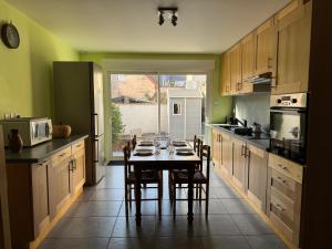a kitchen with a table and chairs in it at L'R Marin in Grand-Fort-Philippe