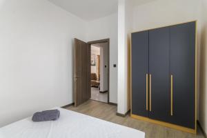 a bedroom with a bed and a black cabinet at Rocky 39 in Grand-Baie +14 photos