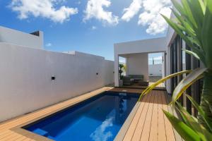 a swimming pool in the backyard of a house at Rocky 39 in Grand-Baie