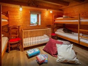 a bedroom with bunk beds in a log cabin at Chalet Le Meridien Etale - OVO Network in Manigod +13 photos