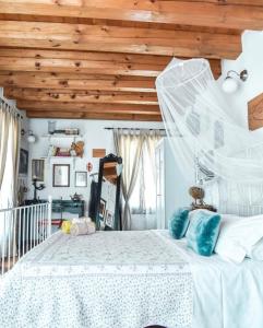 a bedroom with a white bed with a wooden ceiling at Locanda San Tomaso in Treviso