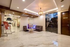 a lobby with chairs and a table in a building at Hotel PK Residency Sector 18 Noida in Noida