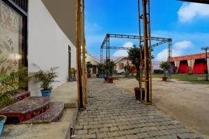 an entrance to a building with a stone walkway at Hotel O R R GARDEN HOTEL in Kānpur