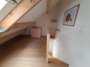 a attic room with a staircase and wooden floors at maison POULDU in Clohars-Carnoët