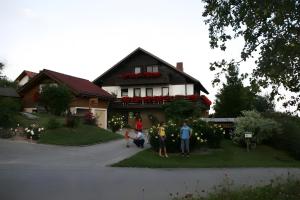 a group of people standing in front of a house at Ferienwohnungen Tröndle in Weilheim