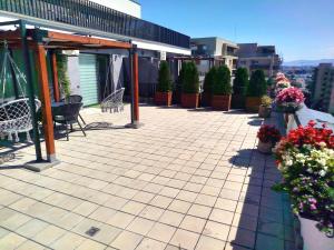a patio with flowers on the roof of a building at Penthouse City View Infinity in Braşov