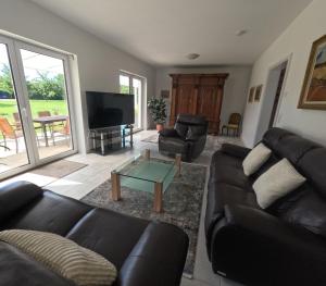 a living room with a couch and a coffee table at Haus Wiesenblick in Königs Wusterhausen +1 photo