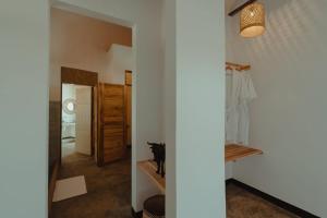 a room with a hallway with a cat sitting on a shelf at Foot On Africa Safari Lodge in Mto wa Mbu