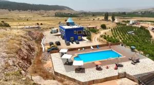 an aerial view of a blue building with a swimming pool at Gîte Forest Tagroumet traditionel in Ifrane