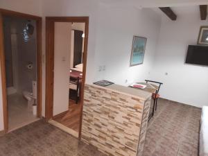 a room with a counter and a bathroom with a toilet at Apartments RGETO in Ston