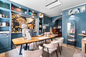 a dining room with blue walls and a table and chairs at Quinta Colina by Shiadu in Lisbon