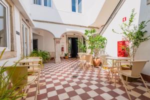 a room with a checkered floor and tables and chairs at Quinta Colina by Shiadu in Lisbon