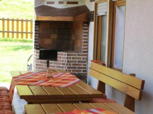 a table and bench in front of a brick fireplace at Ferienwohnung Faller in Elzach +2 photos