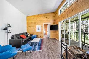 a living room with a couch and a table at Spa Nature & Riverside Escape - Ecureuil Roux in Trois Rives