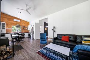 a living room with a couch and a dining room at Spa Nature & Riverside Escape - Ecureuil Roux in Trois Rives