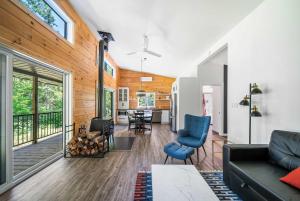 a living room with a couch and chairs and a table at Spa Nature & Riverside Escape - Ecureuil Roux in Trois Rives +27 photos