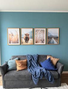 a group of pictures on a wall above a couch at Apartmenthaus Gilden 7 in Borken +10 photos