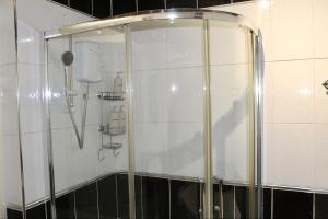 a shower in a bathroom with a phone on the wall at 4 bedroom home with games room - perfect for families, groups and contractors! in Thornhill +34 photos