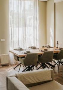 a dining room with a large wooden table and chairs at Naest - Authentic Escapes Old Town Villa Nijmegen in Nijmegen