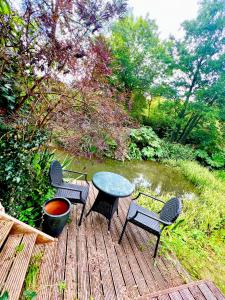 a table and four chairs on a wooden deck at Storeybook cottage in Oswestry +2 photos