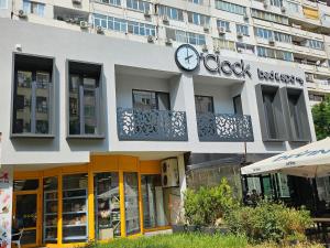 a building with a clock on the front of it at O'clock bed & SPA in Burgas City