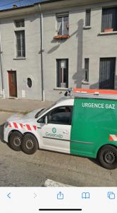 a green and white car parked in front of a building at Le Cocon de la Gare de Grenoble in Grenoble