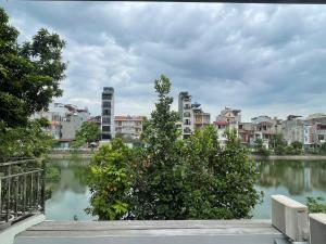 a view of a city with buildings and a body of water at The Rose House-Lakeview Long Bien in Hanoi