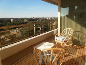 a balcony with two chairs and a table with a view at Hotel TOmz2 in Cilandak
