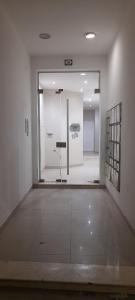 an empty room with a glass door in a building at La Margarita in Argentina