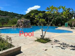 a pool at a resort with the word pool at El Jona De Residencia 2 in Davao City