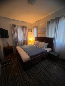 a bedroom with a bed in a room with curtains at El Jona De Residencia 2 in Davao City +21 photos