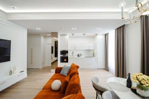 a living room with a couch and a table at Stylish Downtown Stay in Chişinău