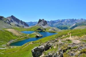 a mountain lake in the middle of a green valley at Civico 18 Guest House in Cuneo