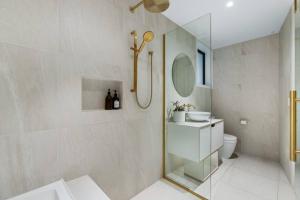 a bathroom with a shower and a toilet and a sink at Alpine Hideaway Eco Retreat in Wanaka