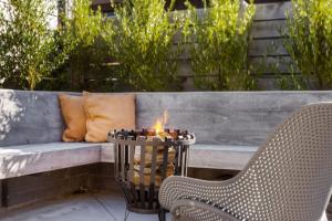 a bench with a table and two chairs and a candle at Alpine Hideaway Eco Retreat in Wanaka