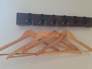 a bunch of wooden utensils hanging from a rack at Alpine Hideaway Studio in Wanaka