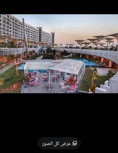 a view of a resort with a pool and tables at بورتو كايرو التجمع الخامس in Cairo