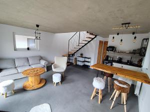 a living room with a couch and a table at Chalúpky pod Viaduktom in Telgárt