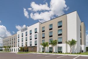 an image of a rendering of the exterior of a hotel at StudioRes by Marriott Fort Myers Airport in Miromar Lakes