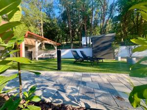 a patio with two chairs in a yard at Silent Lake in Látrány