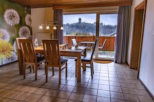 a dining room with a table and chairs with a view at Hotel Burgblick in Thallichtenberg