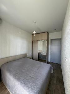 a bedroom with a large bed in a room at Shekvetili Small Wonder in Shekhvetili
